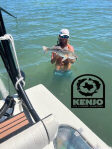 Fly Guide Capt Kenjo holds rescued redfish. Take your Texas Redfish Fly Fishing Adventures with KenjoFly!